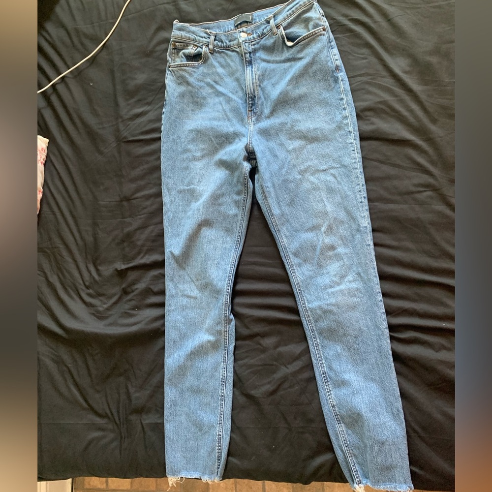 Light blue jeans with distressed cuffs